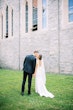 Bride wearing simple crepe wedding dress Bertina by Maggie Sottero.