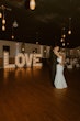 Bride Wearing Simple Fit-and-Flare Wedding Dress Called Fernanda By Maggie Sottero Dancing With Groom