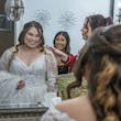 Bride wearing Seneca wedding dress by Sottero and Midgley getting ready