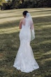 Bride wearing budget friendly fit and flare wedding dress