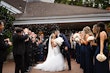 Bride wearing Holden wedding dress by Sottero and Midgley kissing her husband with bubbles