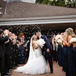 Bride wearing Holden wedding dress by Sottero and Midgley kissing her husband with bubbles